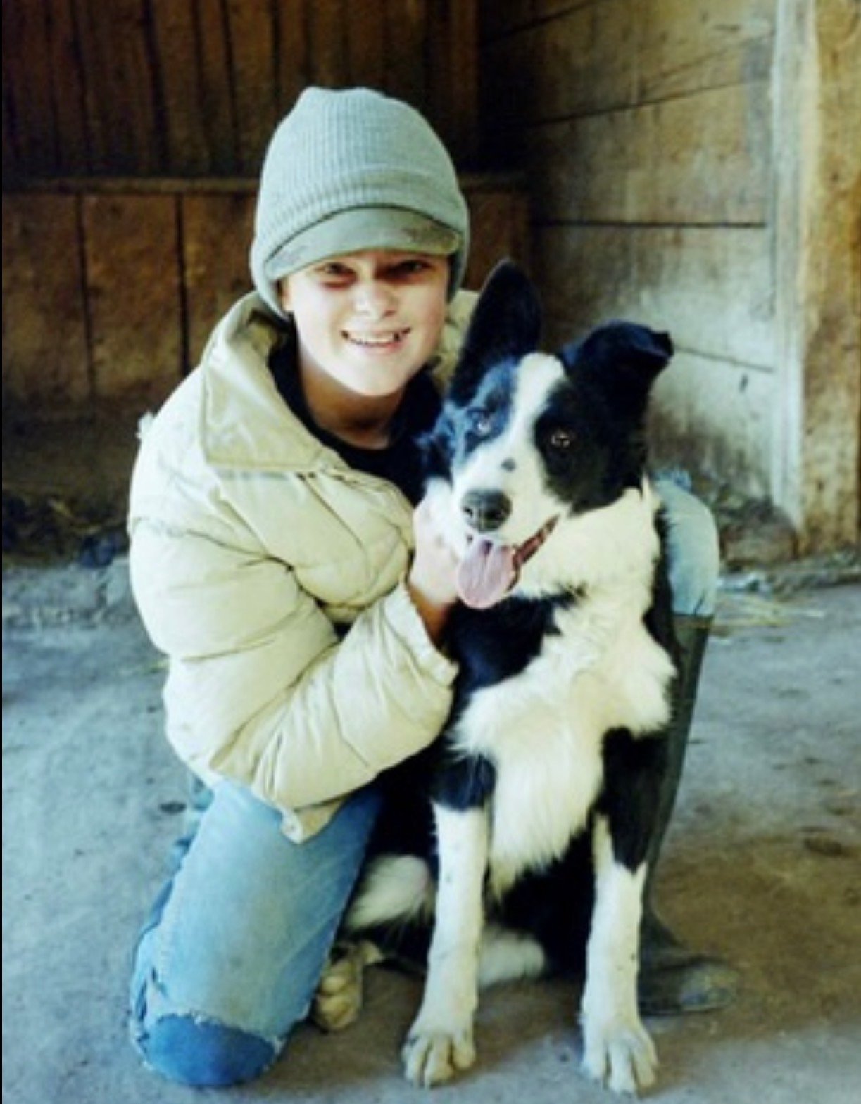 A young Kristen J. Lloyd with her childhood dog on the family farm